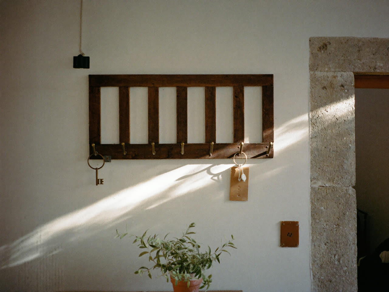Key board in a Malta guesthouse with the last keys hanging, showing a fully booked room in morning light